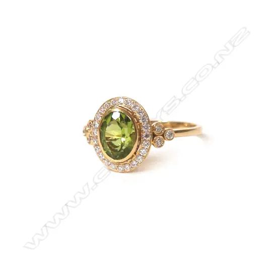 A 19ct. yellow gold peridot and diamond dress ring