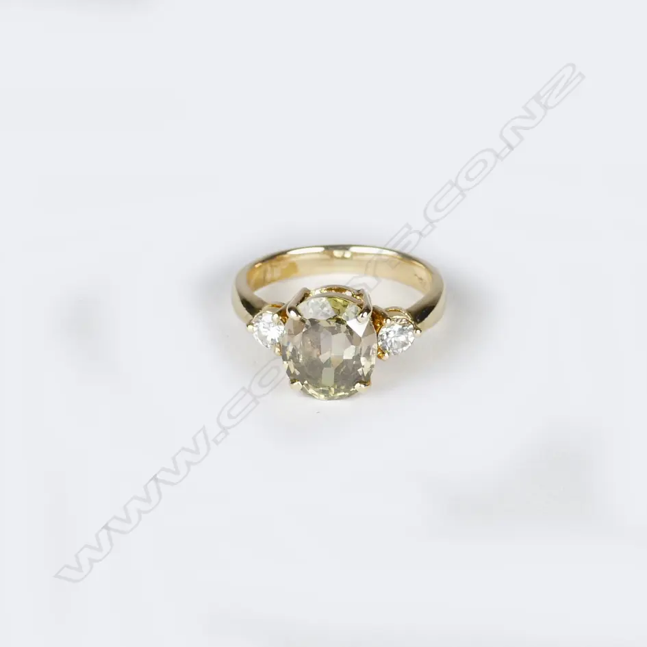 An 18ct. yellow gold peridot and diamond ring Image 1++
