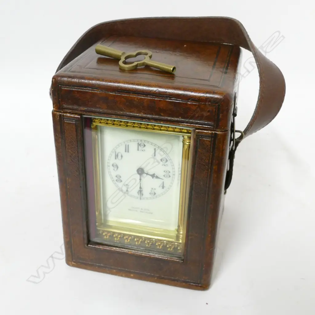 A decorative brass cased carriage clock retailed by Grant & Son Image 1++