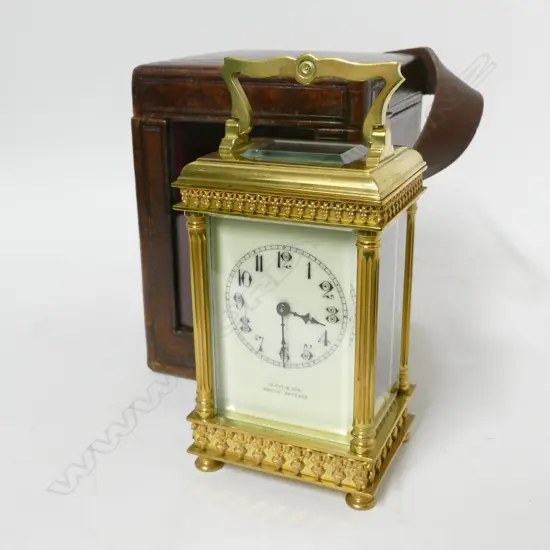 A decorative brass cased carriage clock retailed by Grant & Son