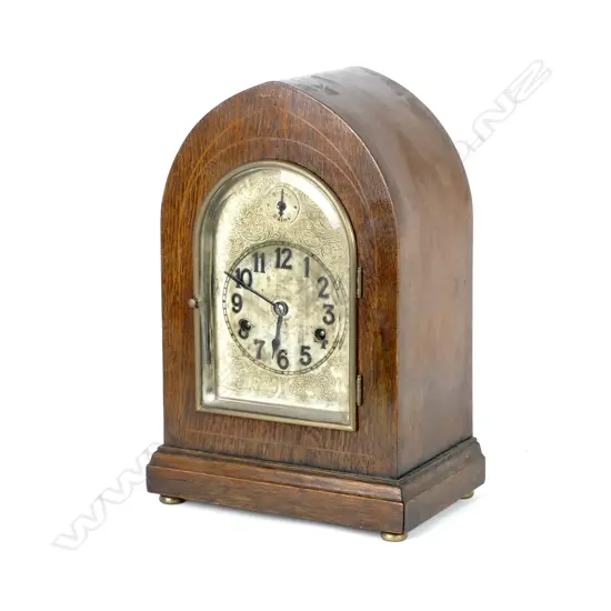 An oak Gothic cased mantel clock