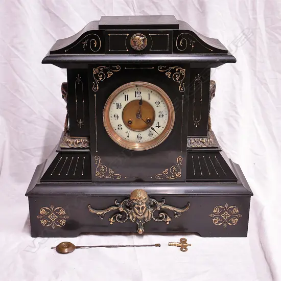 A late 19thC substantial American black slate/marble mantel clock