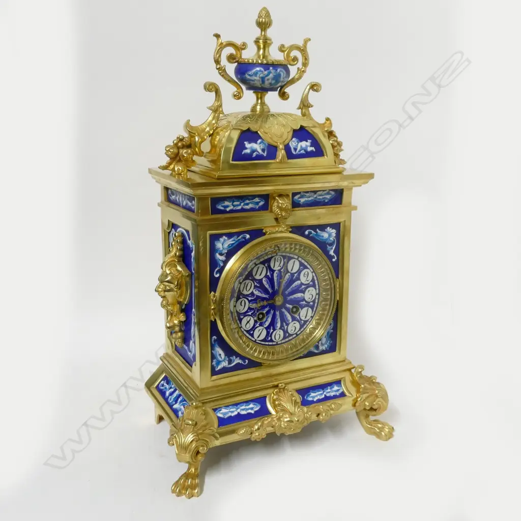 A decorative French mantel clock with blue and white porcelain panelled brass case Image 1++