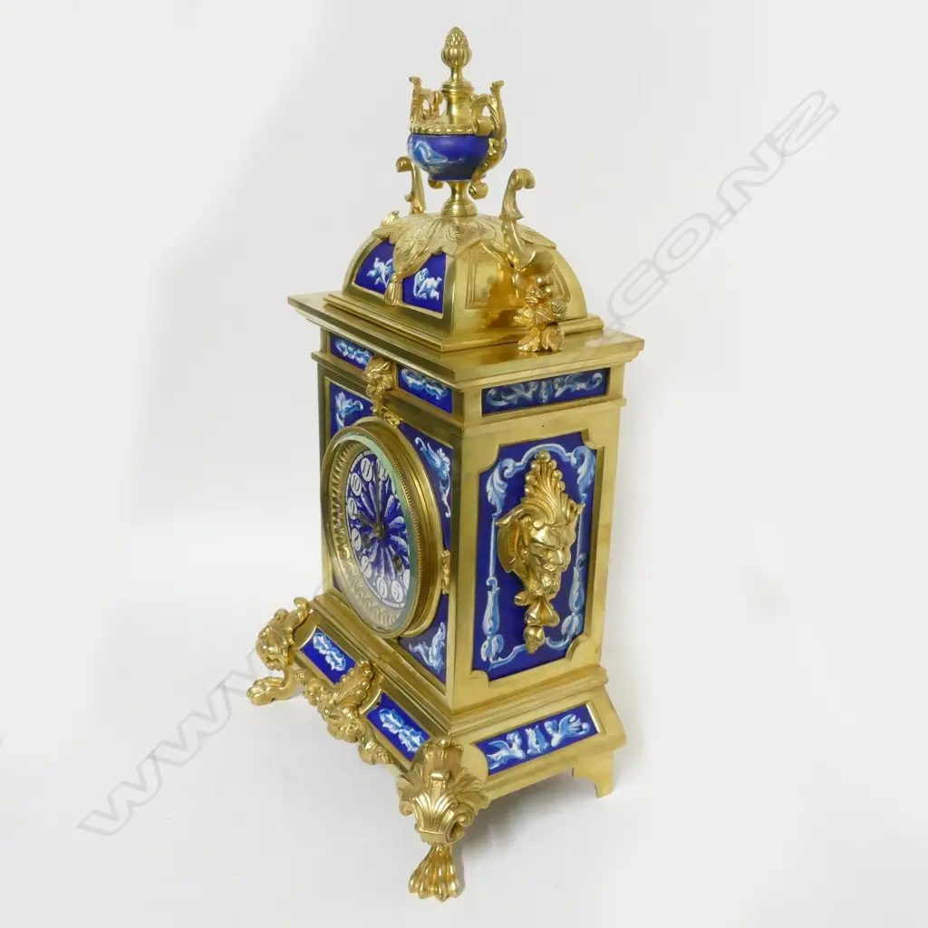 A decorative French mantel clock with blue and white porcelain panelled brass case Image 1++