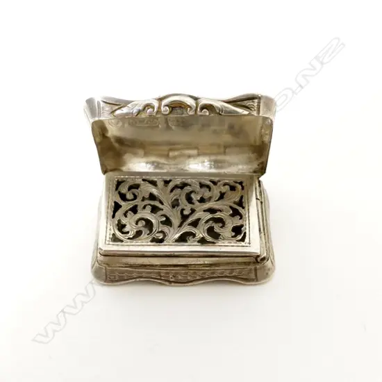 A tiny Victorian engraved silver vinaigrette