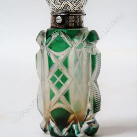 A Victorian silver topped green flashed cut glass scent bottle