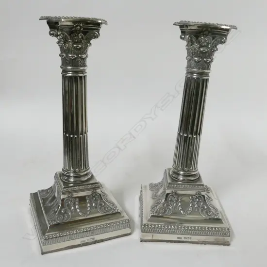 A pair of Edwardian silver Corinthian column candlesticks
