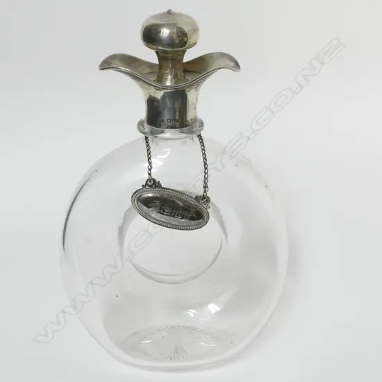 An Edwardian silver mounted glass annular ring decanter