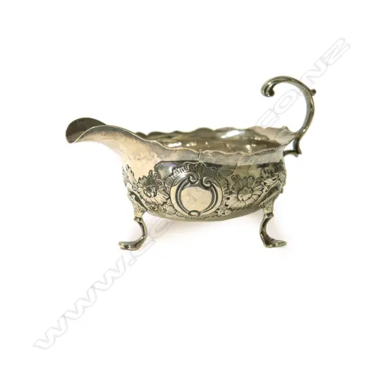 A small George III tripod silver sauce boat