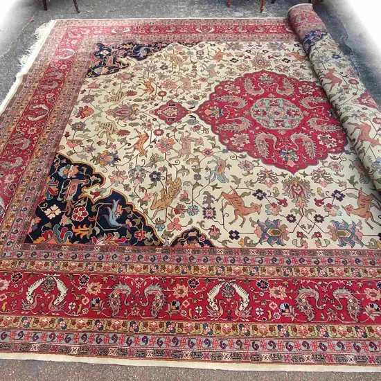A large old hand knotted Persian Heriz hunting carpet
