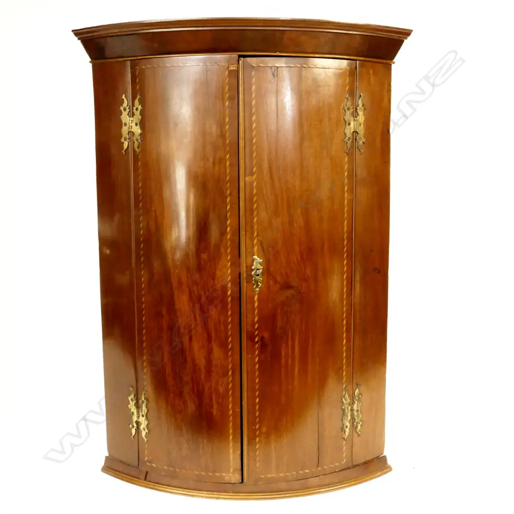 A George III mahogany bowfront corner cabinet Image 1++
