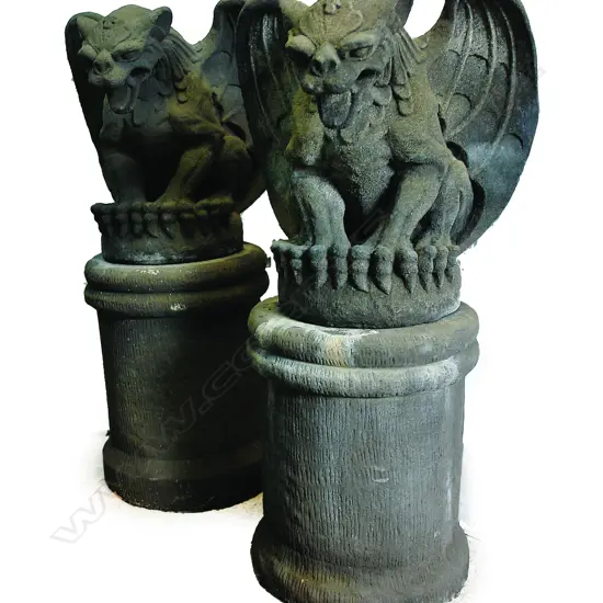 A pair of large seated gargoyles on plinths garden/house entrance sculptures