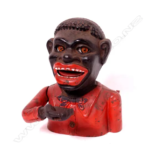 A vintage cast iron Greedy Boy money box