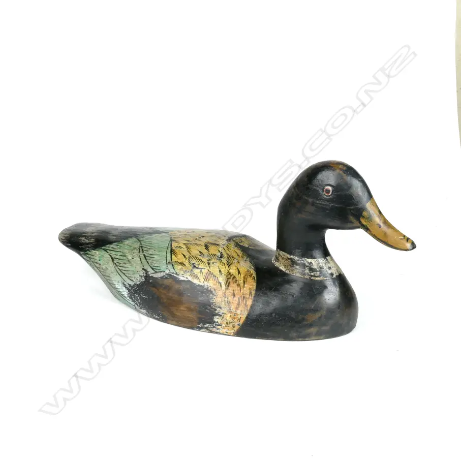 A hand carved and polychrome painted wooden duck decoy Image 1++