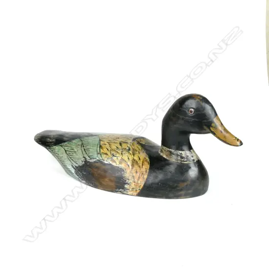 A hand carved and polychrome painted wooden duck decoy