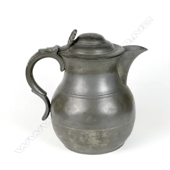 A large pewter lidded flagon with anthemion thumbpiece