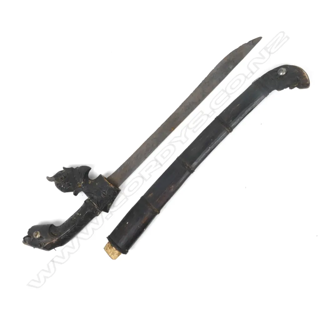 An antique Indonesian knife with a carved animal head handle and original scabbard Image 1++