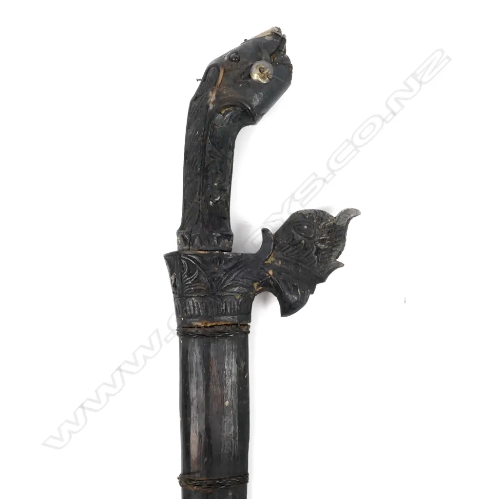 An antique Indonesian knife with a carved animal head handle and original scabbard Image 1++