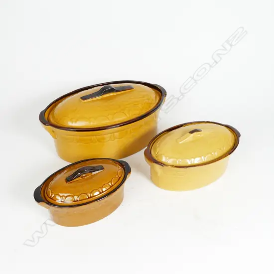 A graduated set of three vintage French lidded casserole pots