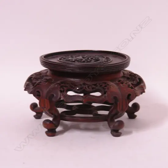 A finely carved hardwood vase stand