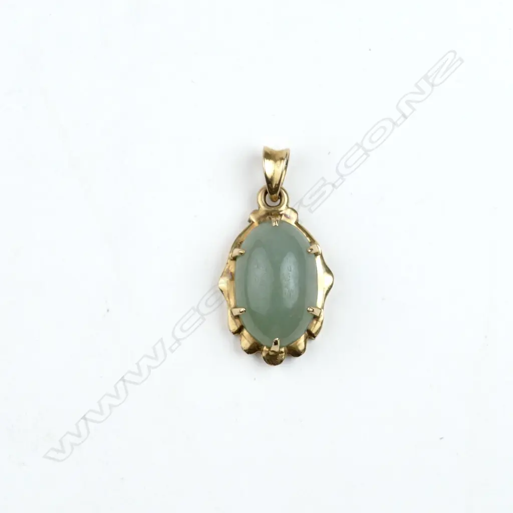 An 18ct. yellow gold mounted jade pendant Image 1++