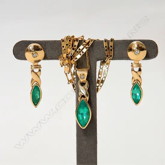 A modern 18ct. yellow gold diamond and emerald pendant necklace and earring set
