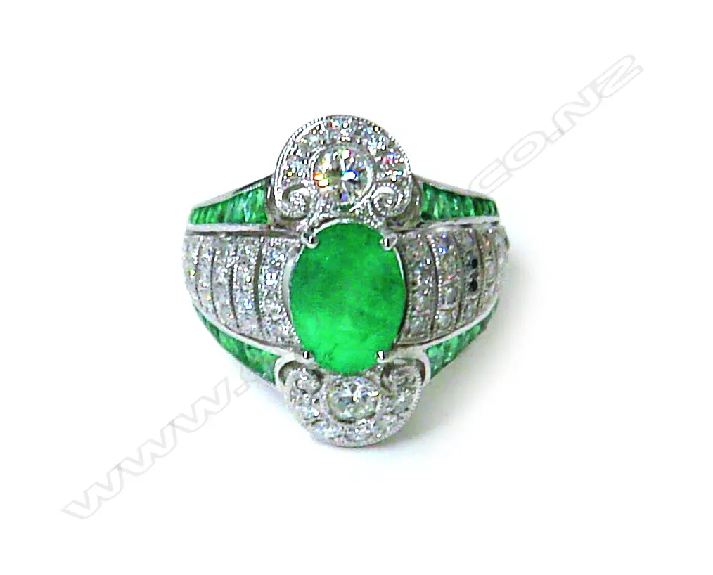 An impressive modern 16-18ct. white gold emerald and diamond cluster ring Image 1++
