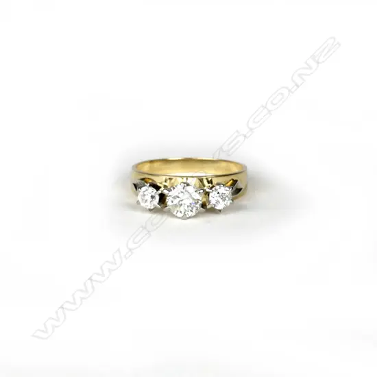 An estate 18ct. gold and three stone diamond ring