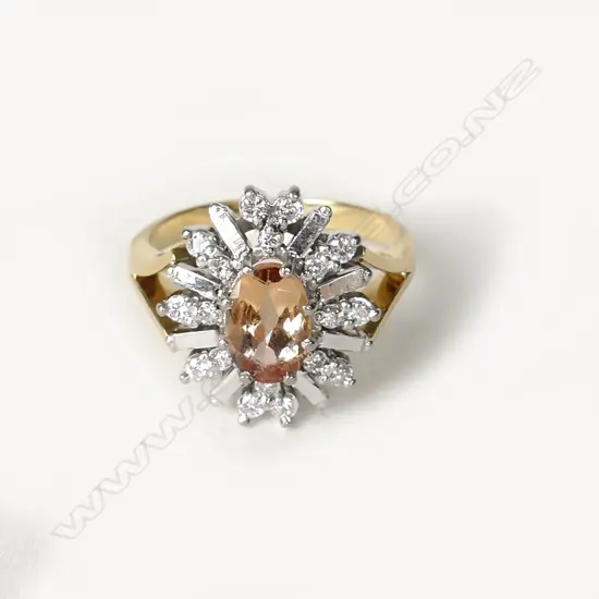 An 18ct. gold diamond and topaz ring