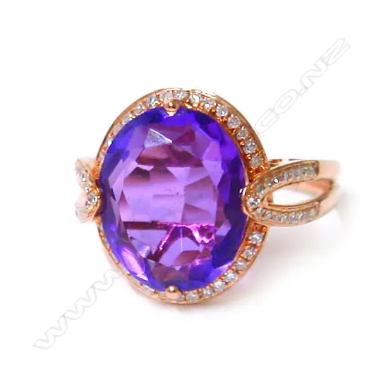 A modern 18ct. rose gold amethyst and diamond dress ring