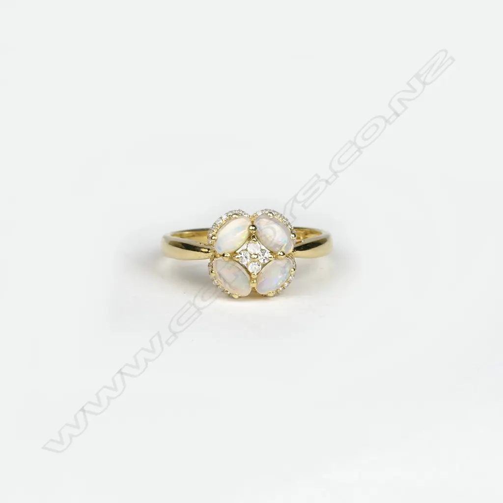 An 18ct. yellow gold opal and diamond cluster ring Image 1++