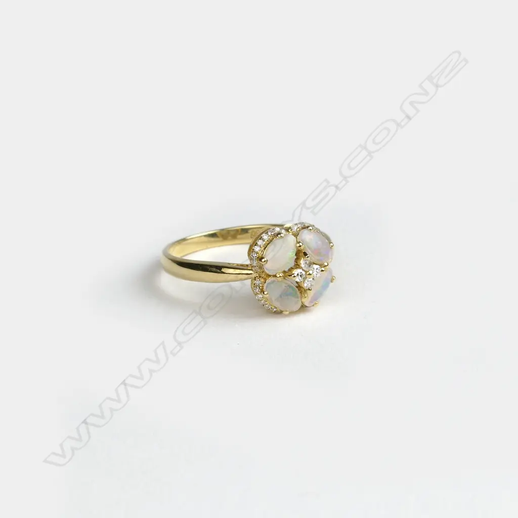 An 18ct. yellow gold opal and diamond cluster ring Image 1++
