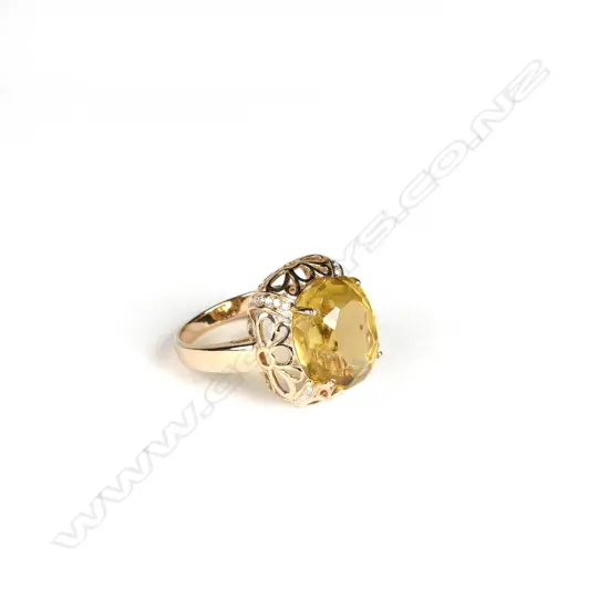 An 18ct. yellow gold large citrine and diamond dress ring