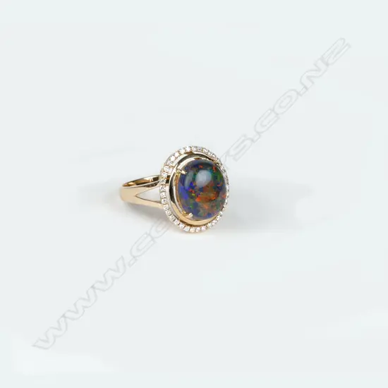 An 18ct. rose gold black opal and diamond dress ring