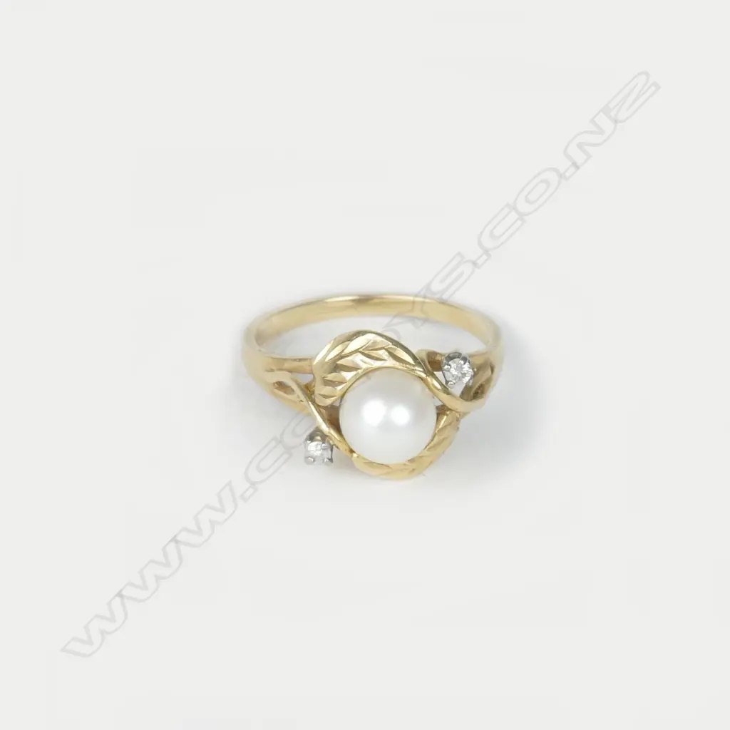 A 14ct. gold diamond and pearl ring Image 1++