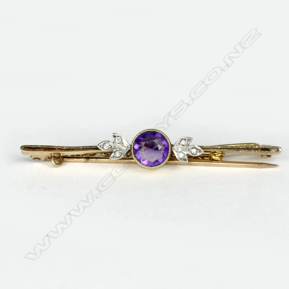 An estate 18ct. gold and platinum amethyst and diamond bar brooch Image 1++