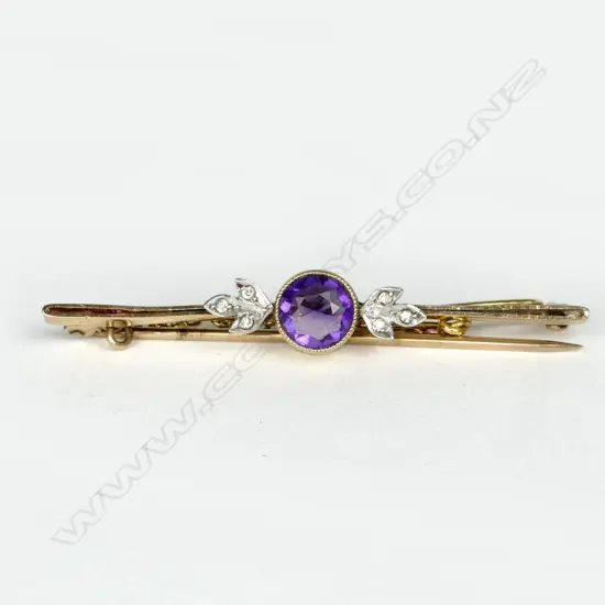 An estate 18ct. gold and platinum amethyst and diamond bar brooch