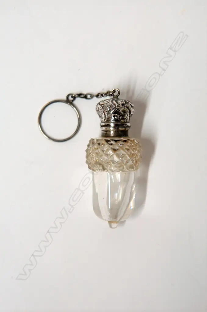 A late 19thC silver topped and cut glass acorn bodied scent bottle Image 1++
