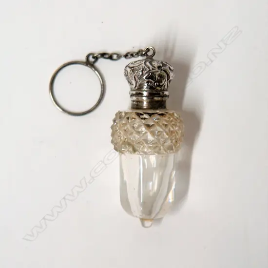 A late 19thC silver topped and cut glass acorn bodied scent bottle