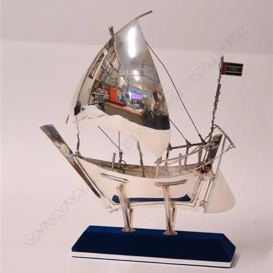 An Eastern silver model sailboat on stand