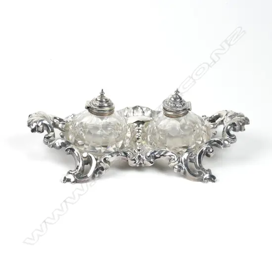 A Victorian crested silver inkstand of rococo style