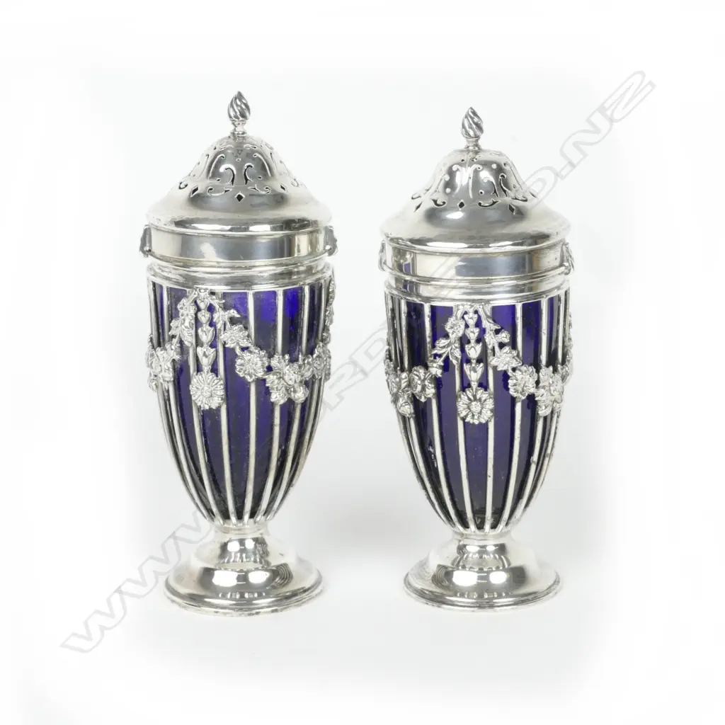 A pair of Edwardian silver vase shaped pepper pots Image 1++