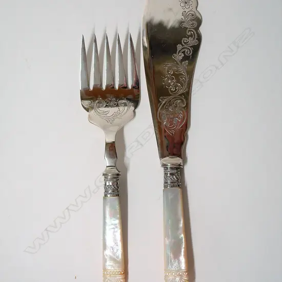 A pair of early 20thC mother-of-pearl handled and silver plate fish servers