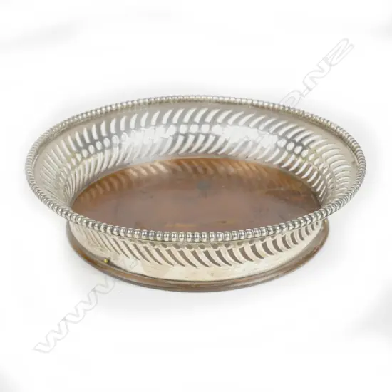 A silver bottle coaster