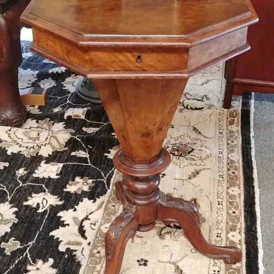 A Victorian figured walnut pedestal sewing table