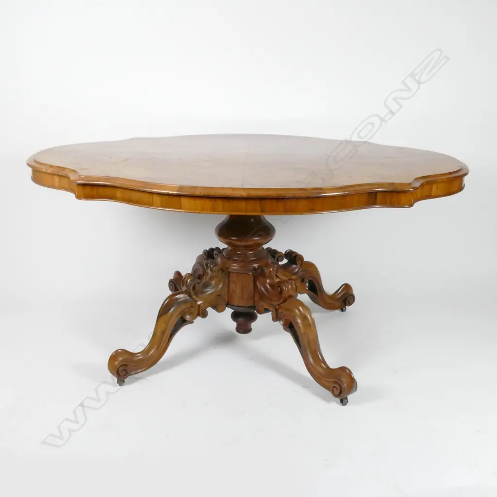 A Victorian walnut serpentine loo table Image 1++
