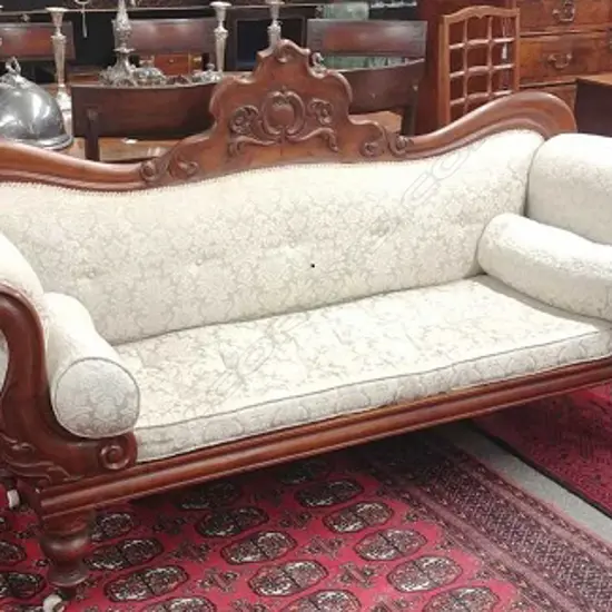 A Victorian mahogany scroll arm settee