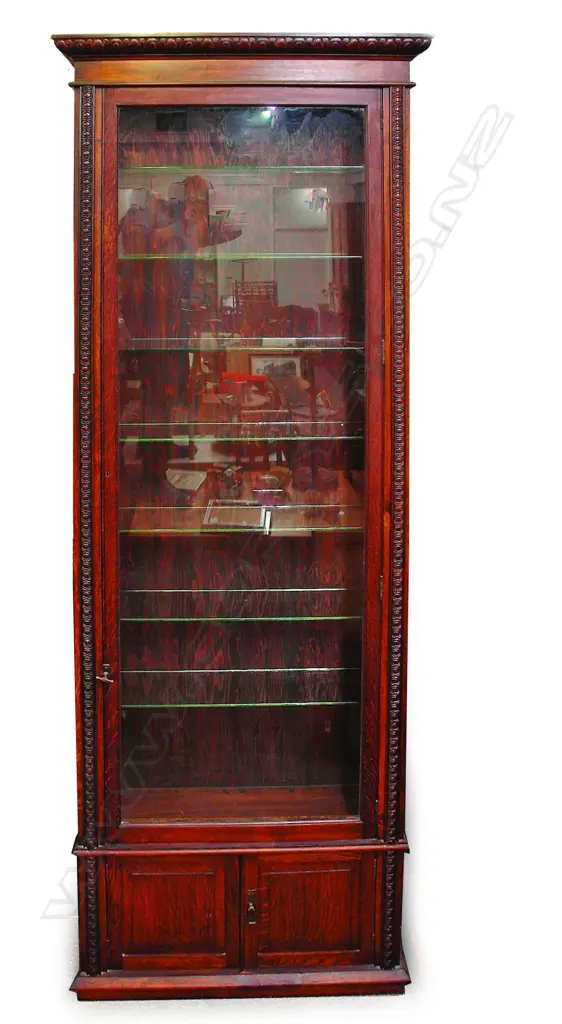An early 20thC oak tall narrow glazed display cabinet Image 1++