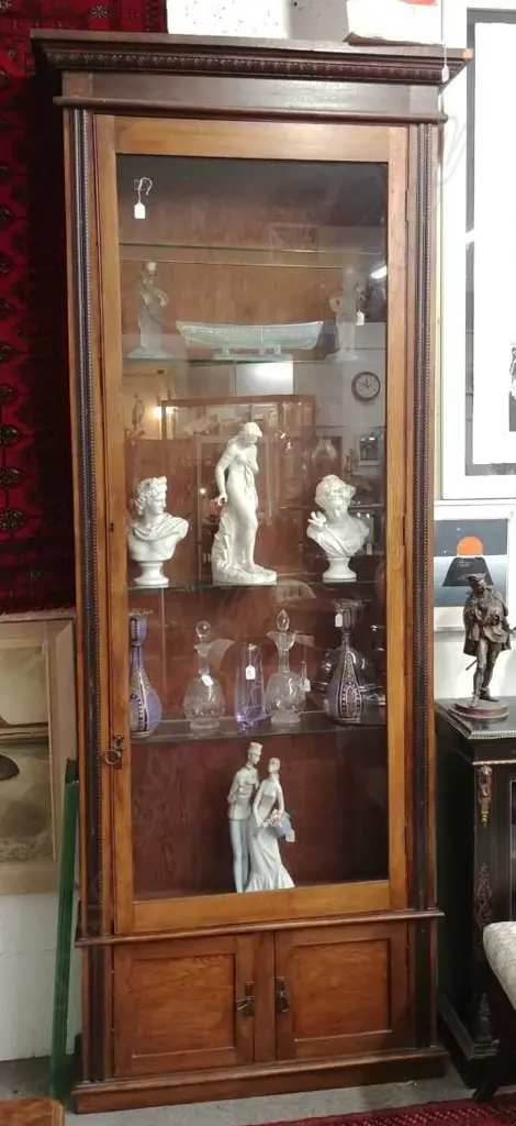 An early 20thC oak tall narrow glazed display cabinet Image 1++