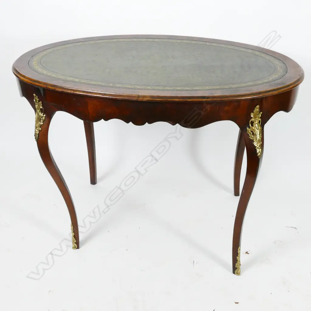 An elegant mahogany oval writing table of French Louis XV style Image 1++
